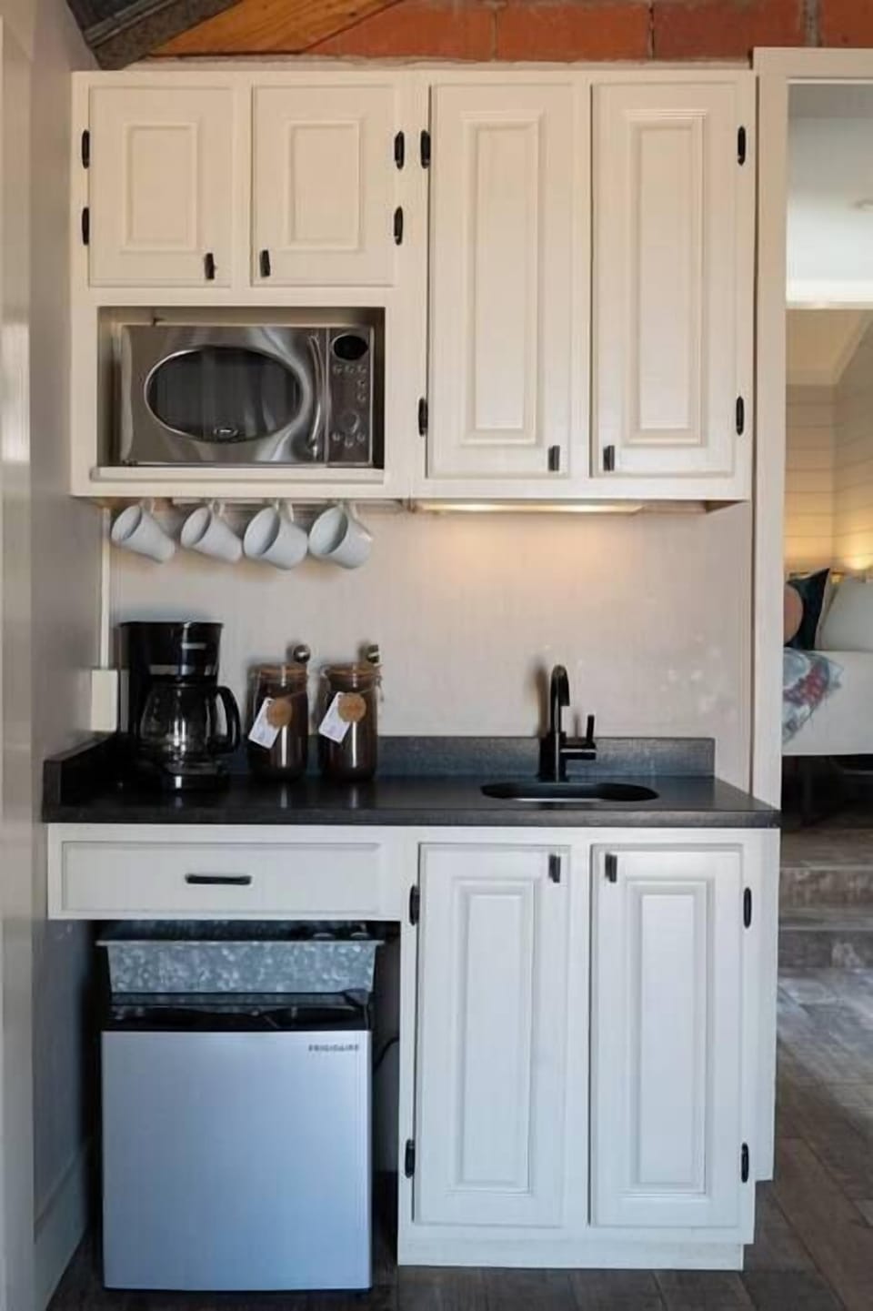 Kitchenette – Mini-fridge, microwave, and sink.