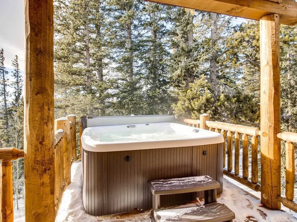 Hot tub five steps from the living room nestled among the pine trees.