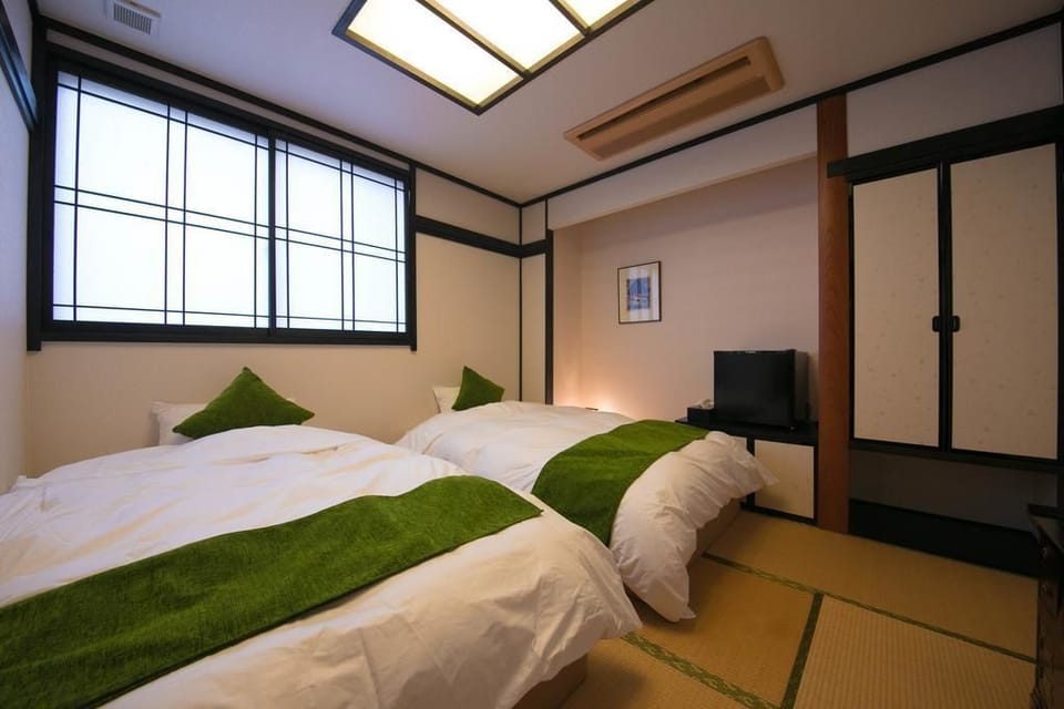 Japanese Western Style Twin Room, Shared Bathroom | Desk, WiFi (free), bed sheets