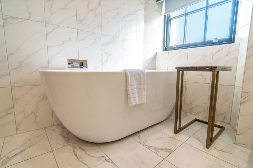 Standard Studio, 1 King Bed | Bathroom | Shower, designer toiletries, slippers, towels