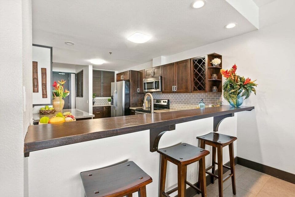 Cook, sip, and socialize in a modern kitchen designed for both style and function, complete with sleek finishes and island flair.