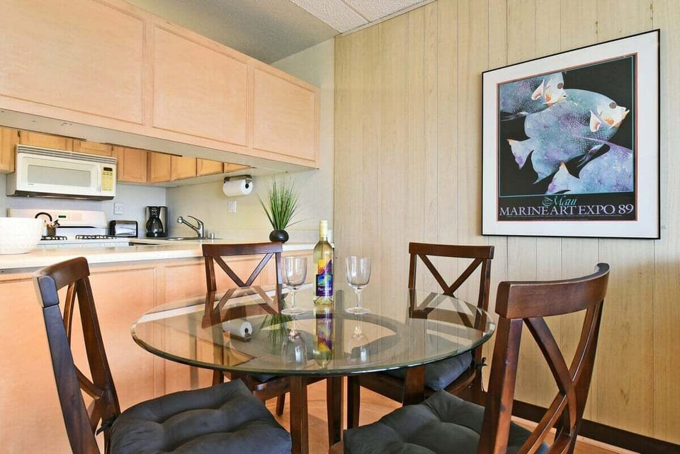 Fully equipped kitchen with dining table and ample cabinet space.