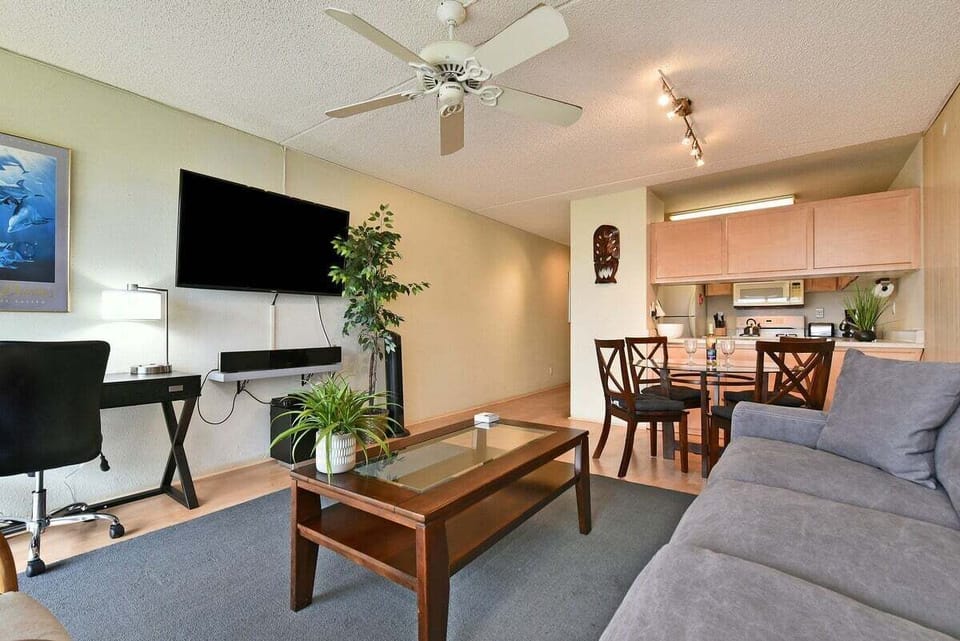 Living room featuring wall‑mounted TV and relaxed open layout.