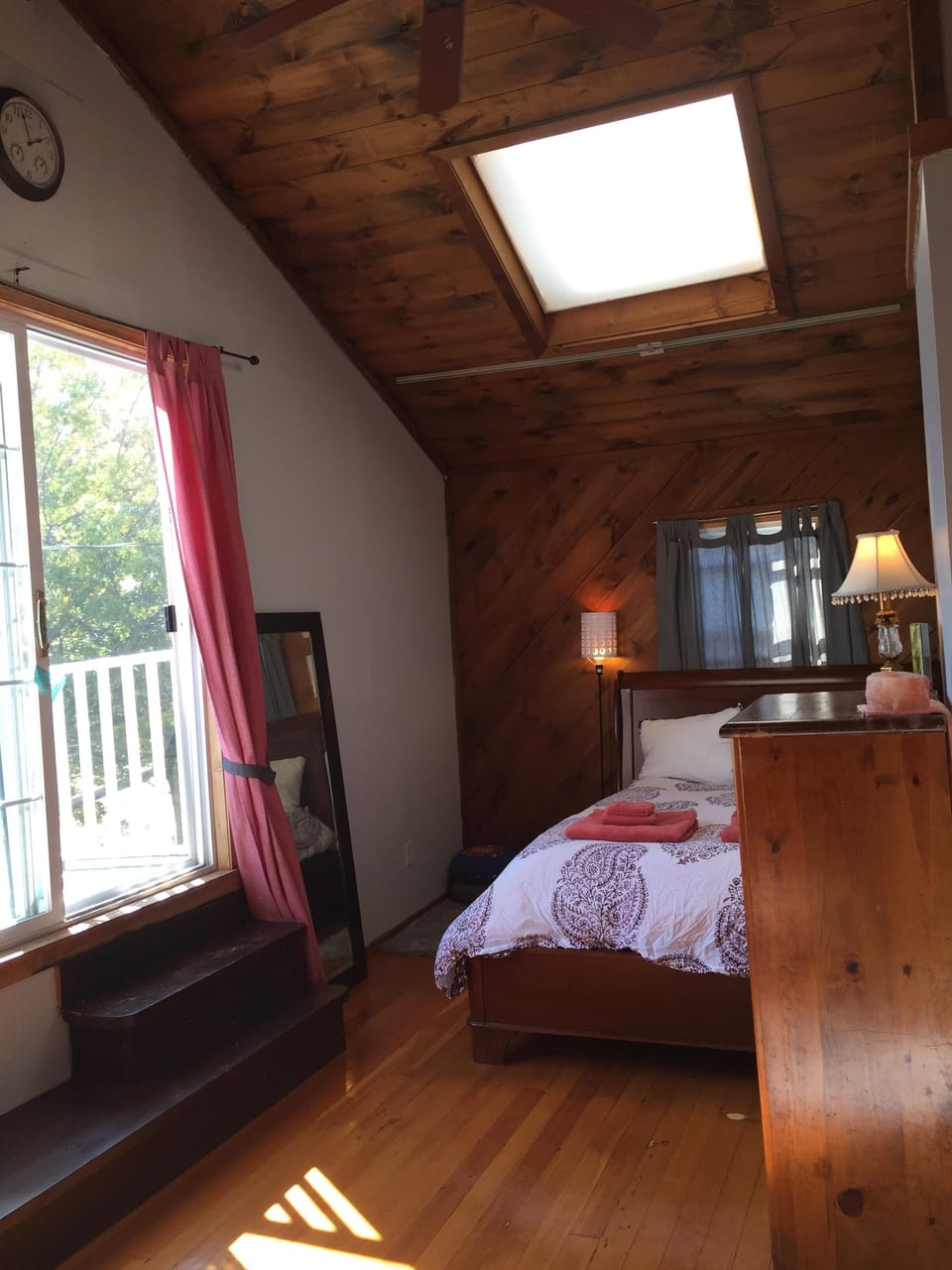 Master bedroom, with view of deck that looks out over water
