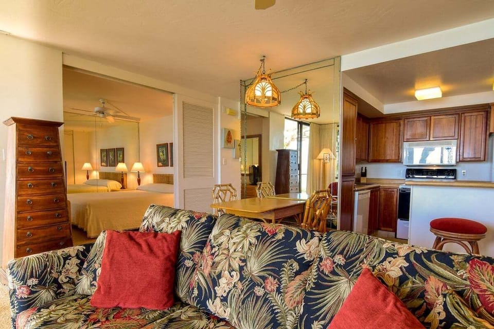 This inviting open space features comfortable seating and a charming dining area, creating a homey atmosphere with tropical flair