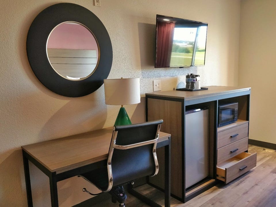 Desk, laptop workspace, blackout drapes, iron/ironing board