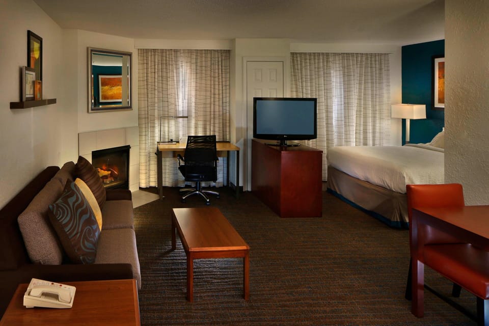 Premium bedding, desk, laptop workspace, blackout drapes