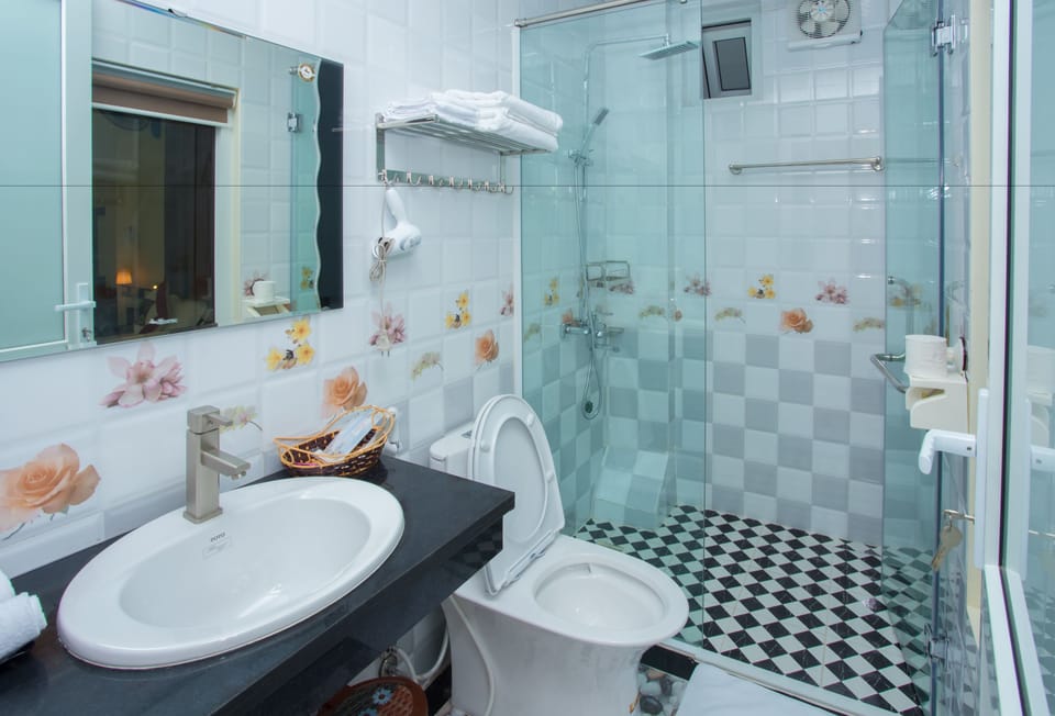 Shower, designer toiletries, hair dryer, slippers