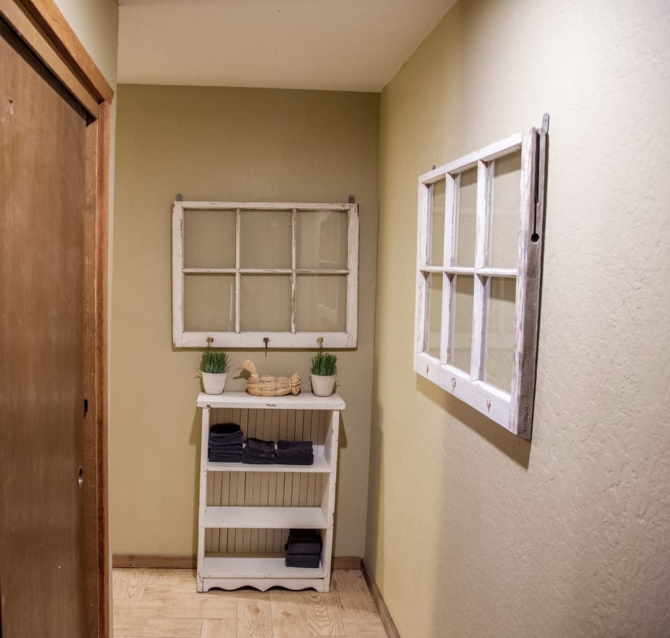 Hallway at the stop of stairs.  Closets to the left for jackets.