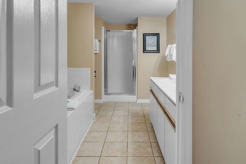 Main bath with a large jetted tub and separate shower.