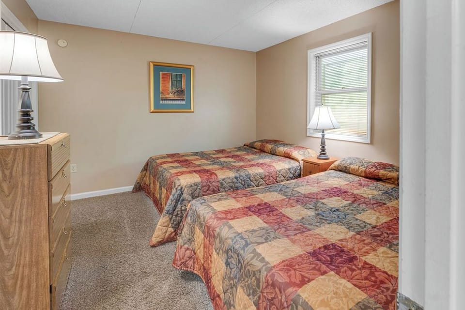 Second bedroom with two queen beds and private bath.
