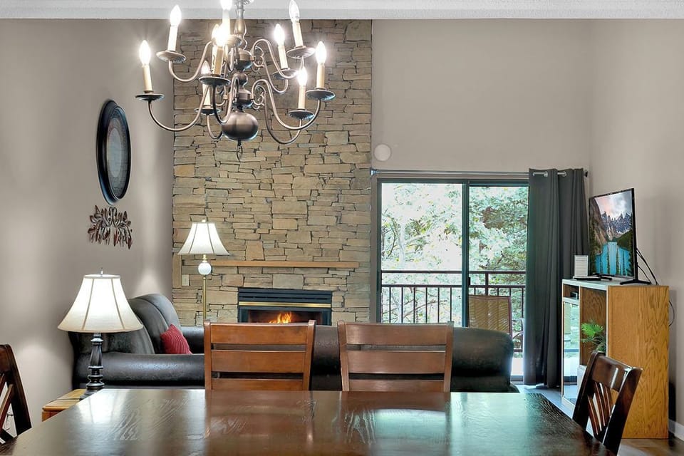 LIving area - A great place for watching a cozy gas fireplace in the cooler months and easy access to the balcony for viewing or listening to the river anytime.