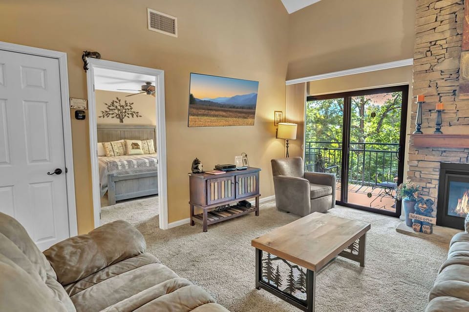 The main bedroom is adjacent to the living area. - A large screen tv and access to the private balcony both accent this living area.