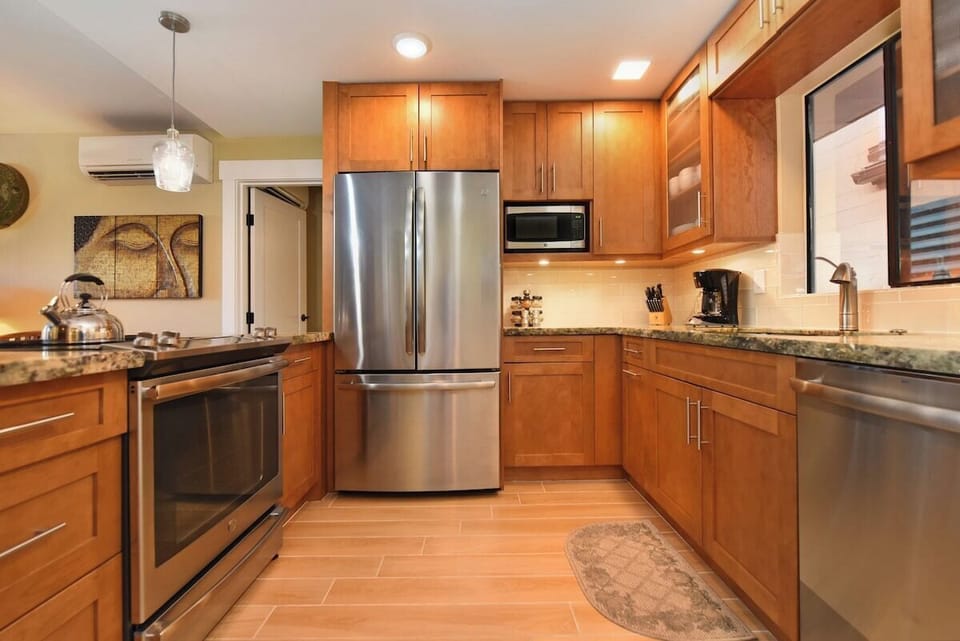Modern kitchen with stainless steel appliances and granite counters — perfect for effortless vacation cooking.