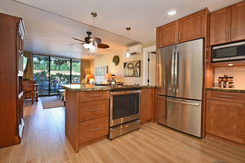 Open kitchen and living area with sliding doors to the patio and garden views.