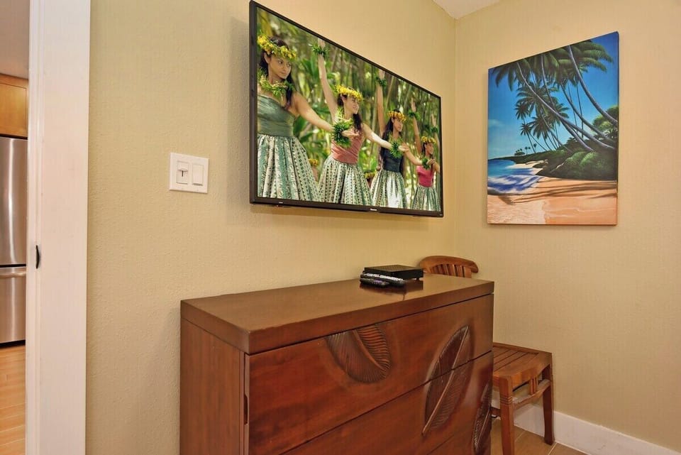 Cozy workspace with desk, chair, and island‑inspired artwork.