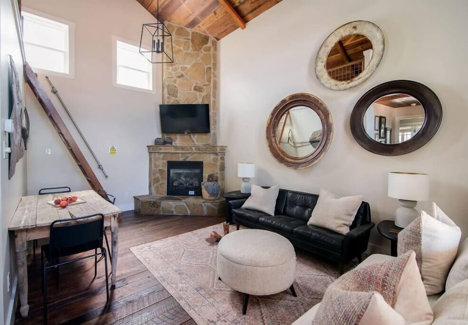 Living room with stone fireplace and Roku TV