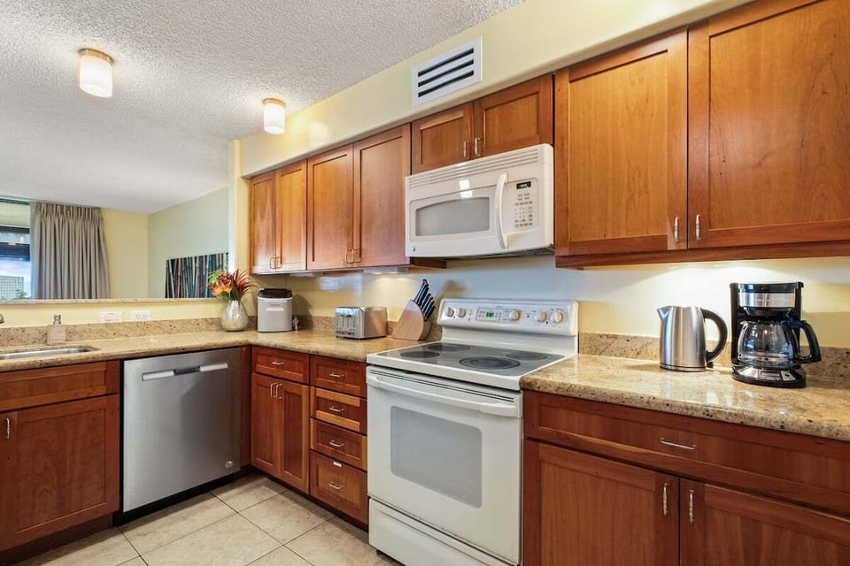 Functional cooking space with updated appliances and warm wood cabinetry