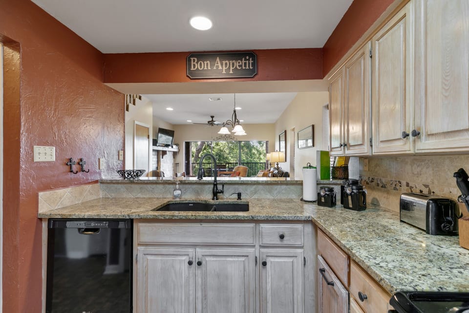 kitchen is stocked with paper towels, dish and dishwasher soap, and trash bags