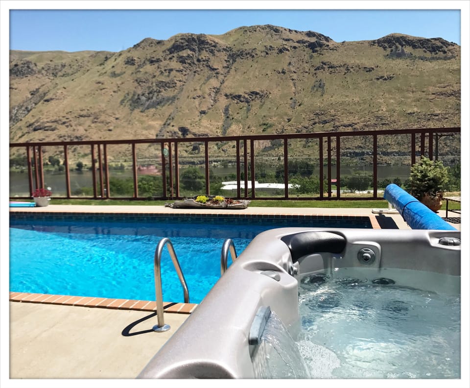 Relax in the hot tub while enjoying the river and mountain views.