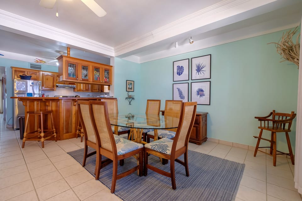 Dining Room and Kitchen.  Bar stools at kitchen counter.