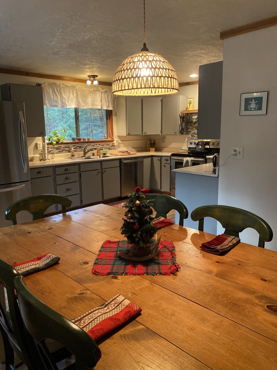 Dining table is open to kitchen and living room, an inviting open floor plan