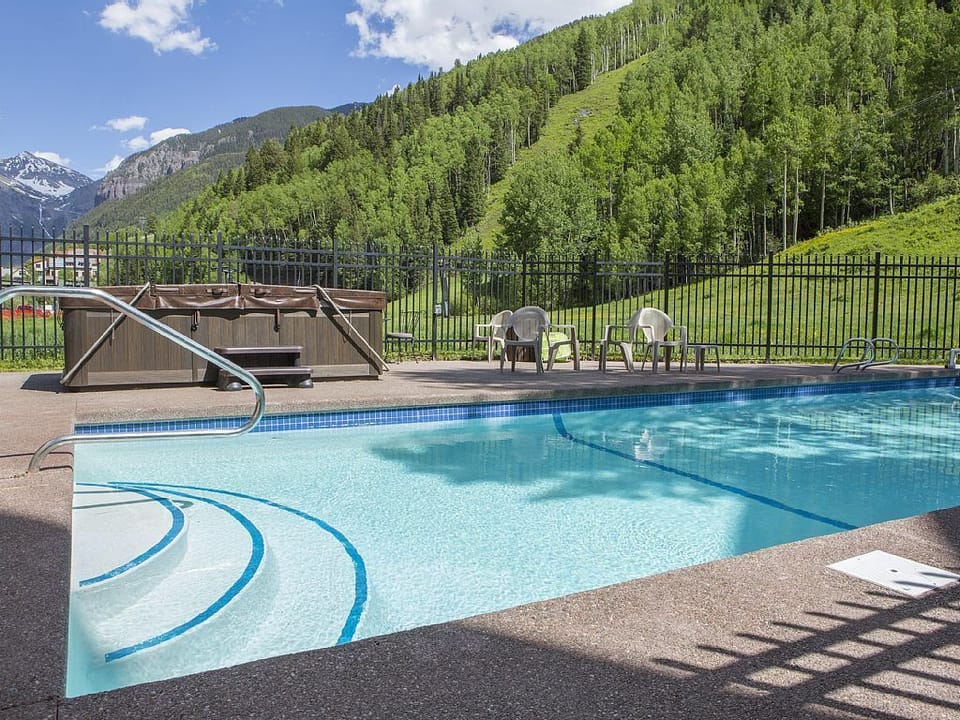 Outdoor heated pool (summer only) and hot tub. A rare amenity in Telluride!