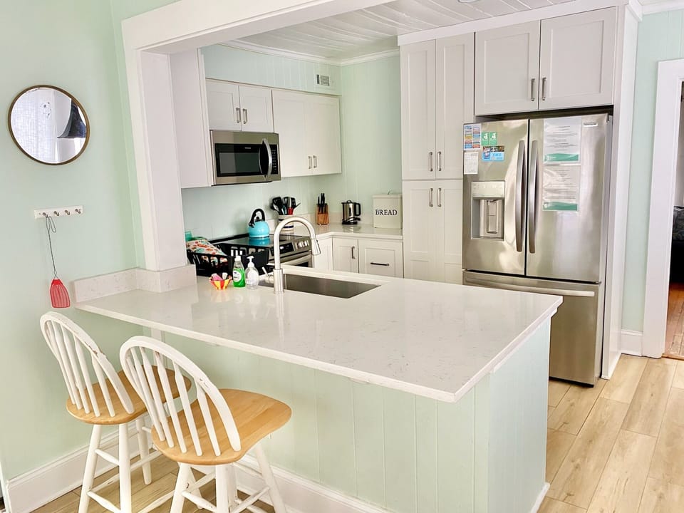 Modernized kitchen with washer and dryer; the living room is to the right and the french doors to the back deck are to your left.