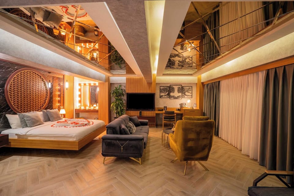 Deluxe Suite, Jetted Tub | Living area | LCD TV
