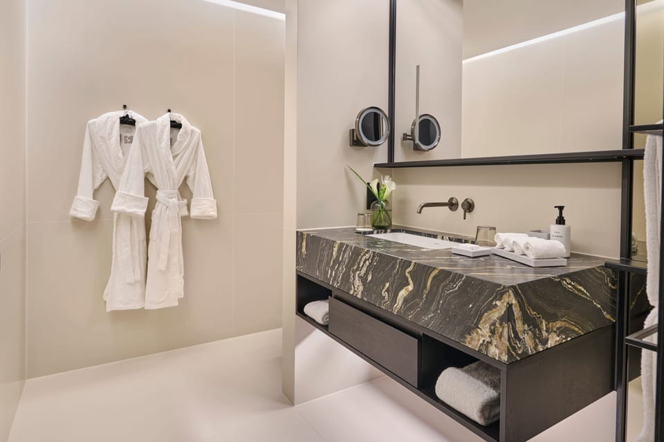 Designer toiletries, hair dryer, bathrobes, slippers