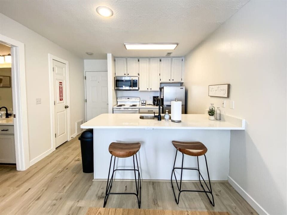 Modern kitchen with breakfast bar and sleek white finishes