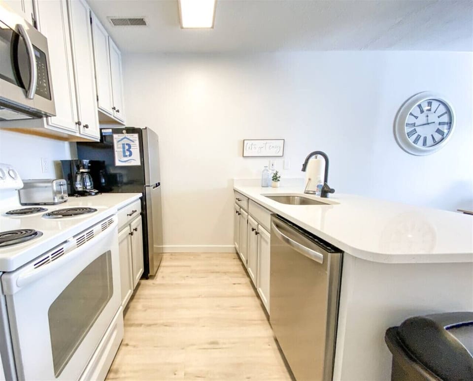 Stylish kitchen with stainless appliances and generous counter space