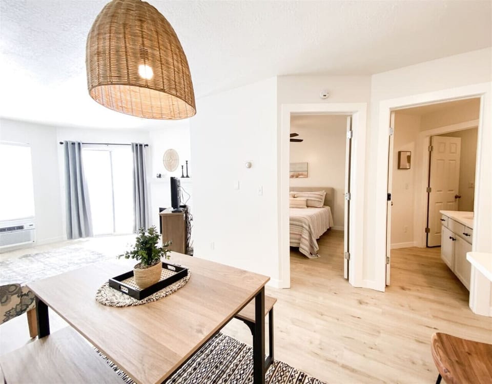Dining area with pendant lighting near bedroom and living space