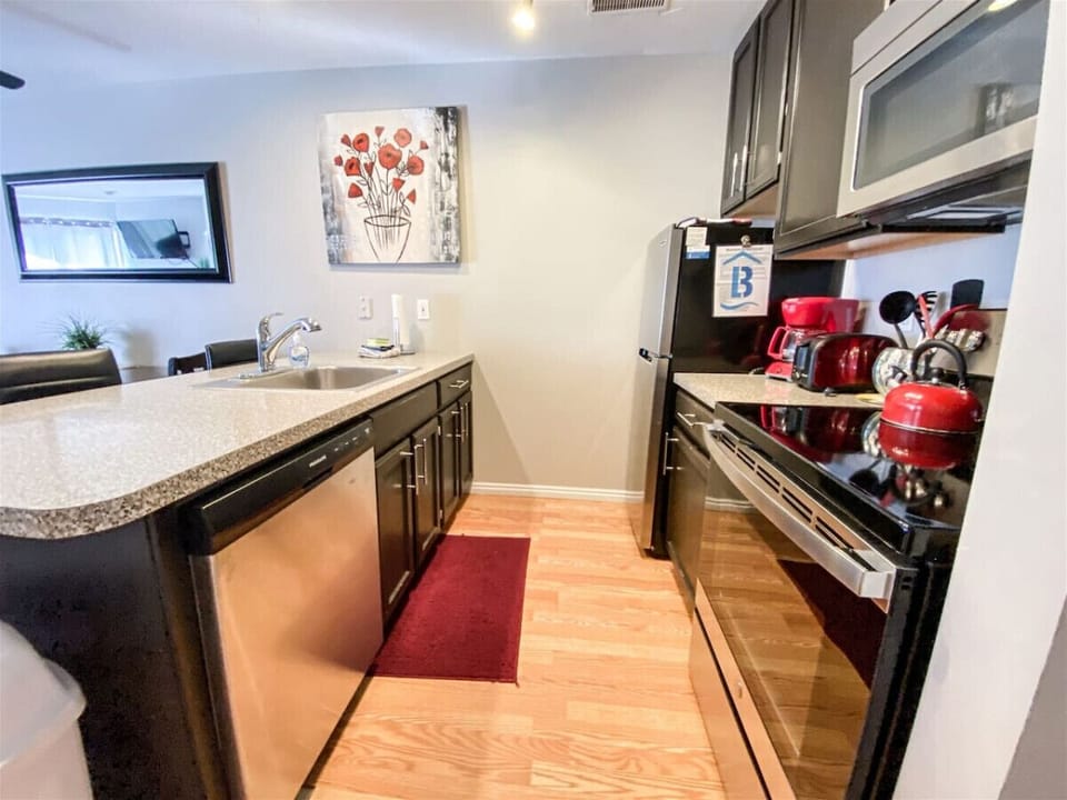Open kitchen with breakfast bar overlooking living space