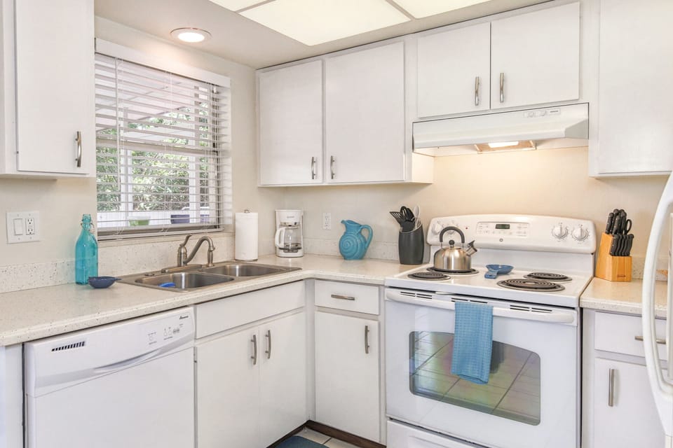 Cheerful bright kitchen is fully stocked and has all the modern conveniences