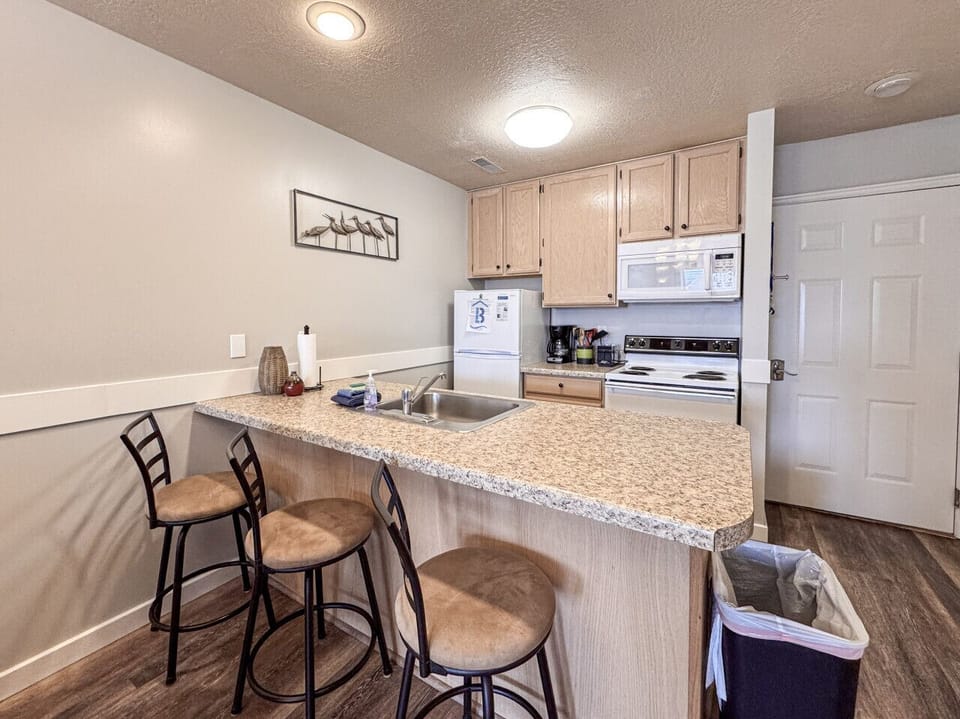 Charming kitchen with bar seating, perfect for casual meals and friendly conversation.