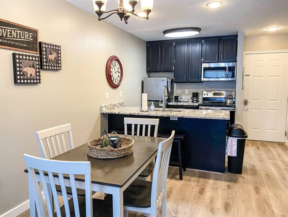 Dining area and breakfast bar beside modern kitchen