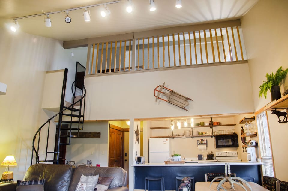 View of loft, kitchen, and front entryway.