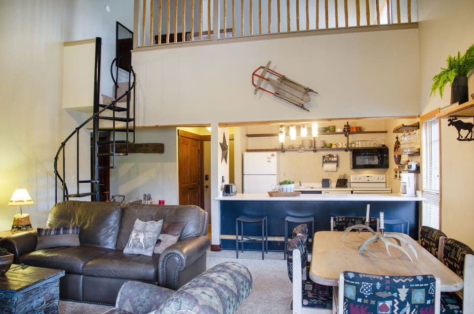 View of living room, kitchen, and loft.