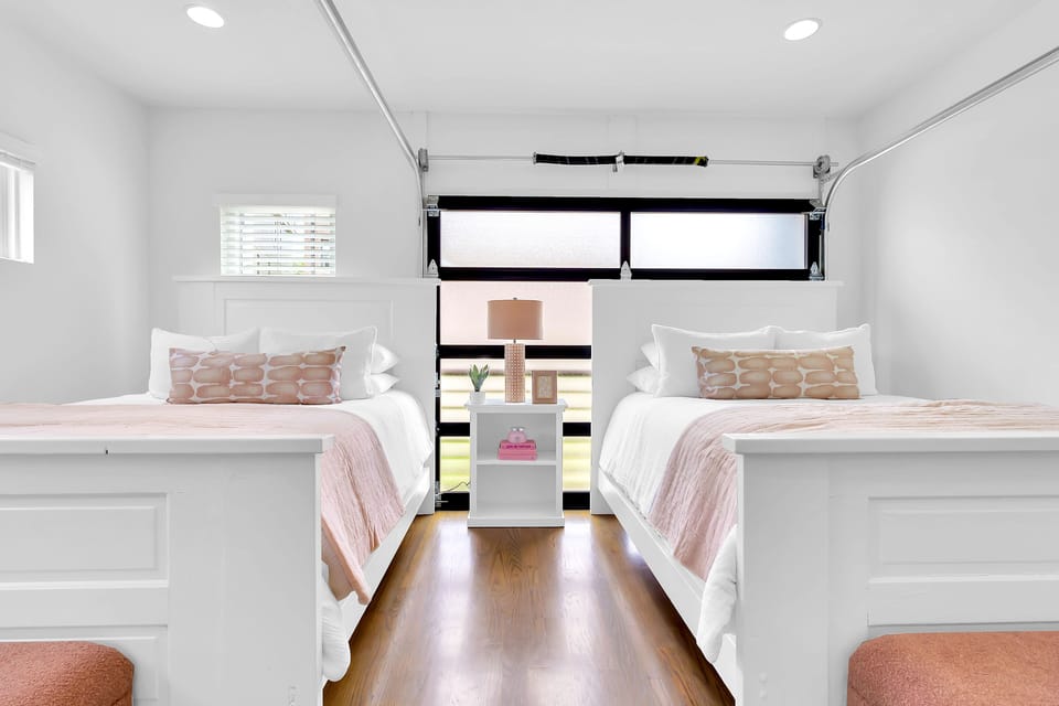 2nd Floor bedroom w/ 2 Queens, TV, closet, and garage door balcony access!
