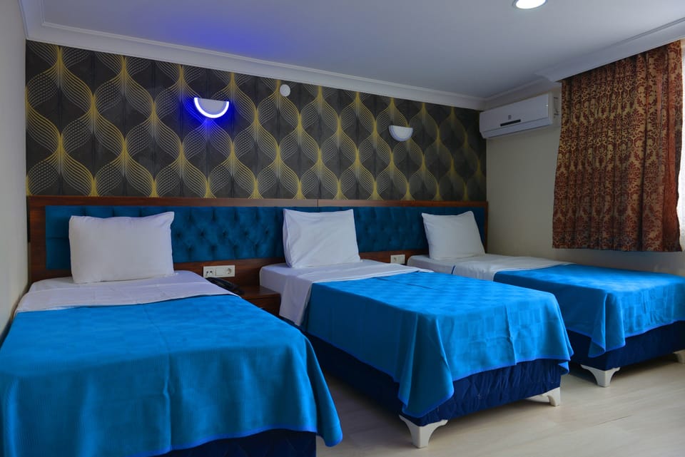 Triple Room | Minibar, in-room safe, desk, soundproofing