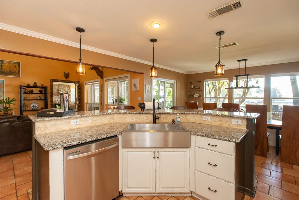 Kitchen sink area with bar stools