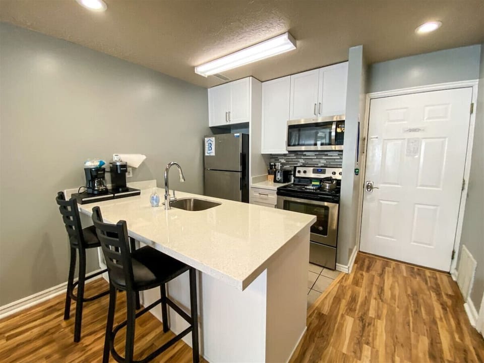 Sleek kitchen with bar seating and modern appliances