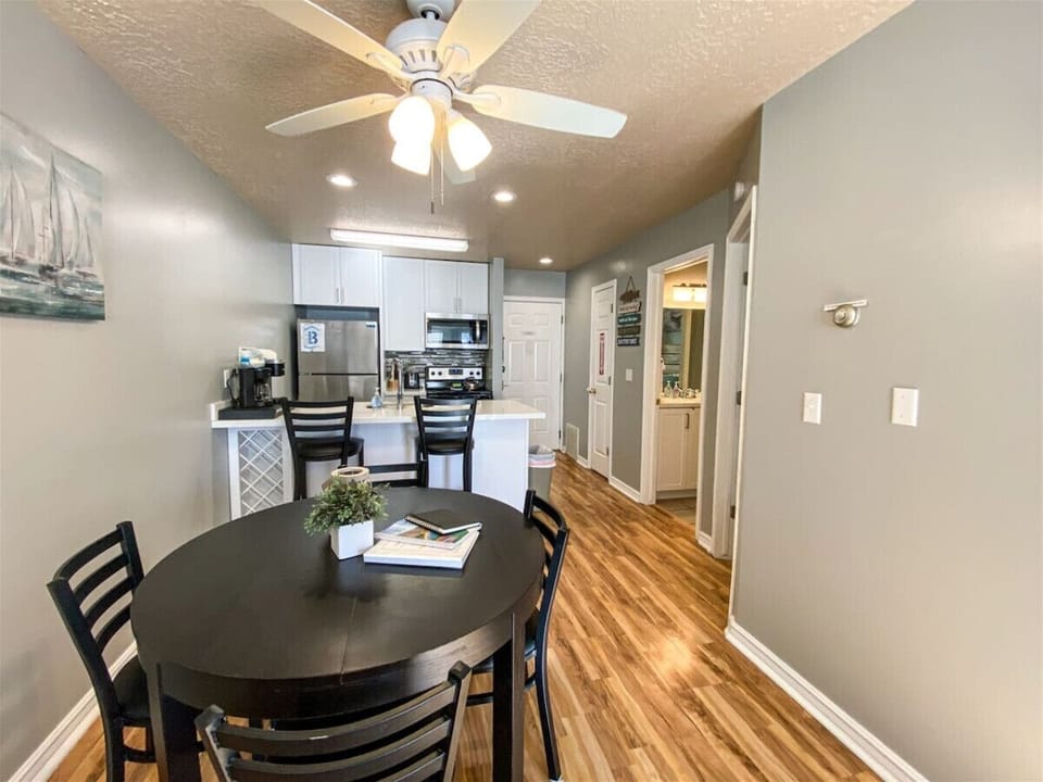 Open layout connecting dining, kitchen, and entryway
