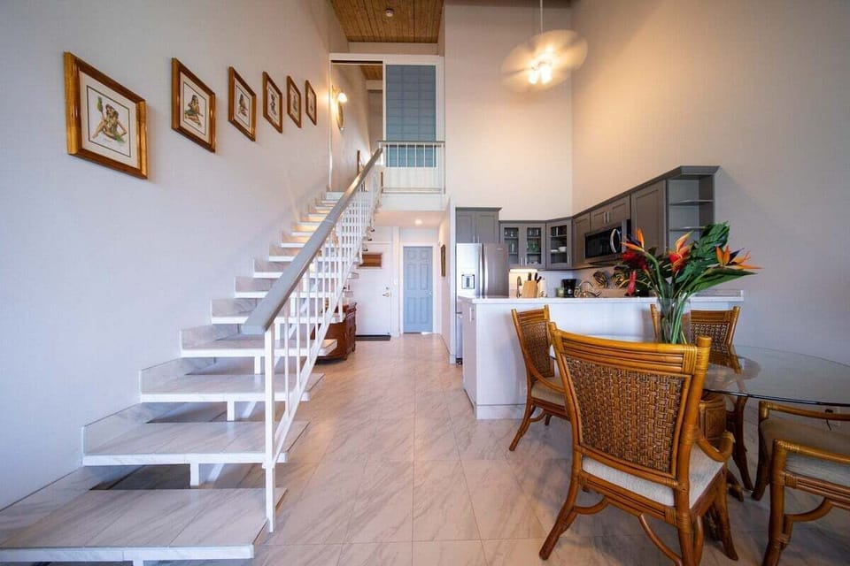 Entry and stairway area leading to upper level with bright, airy design.