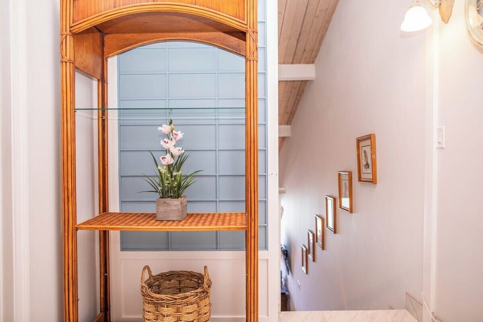 Stairway detail with framed artwork and architectural archway accents.