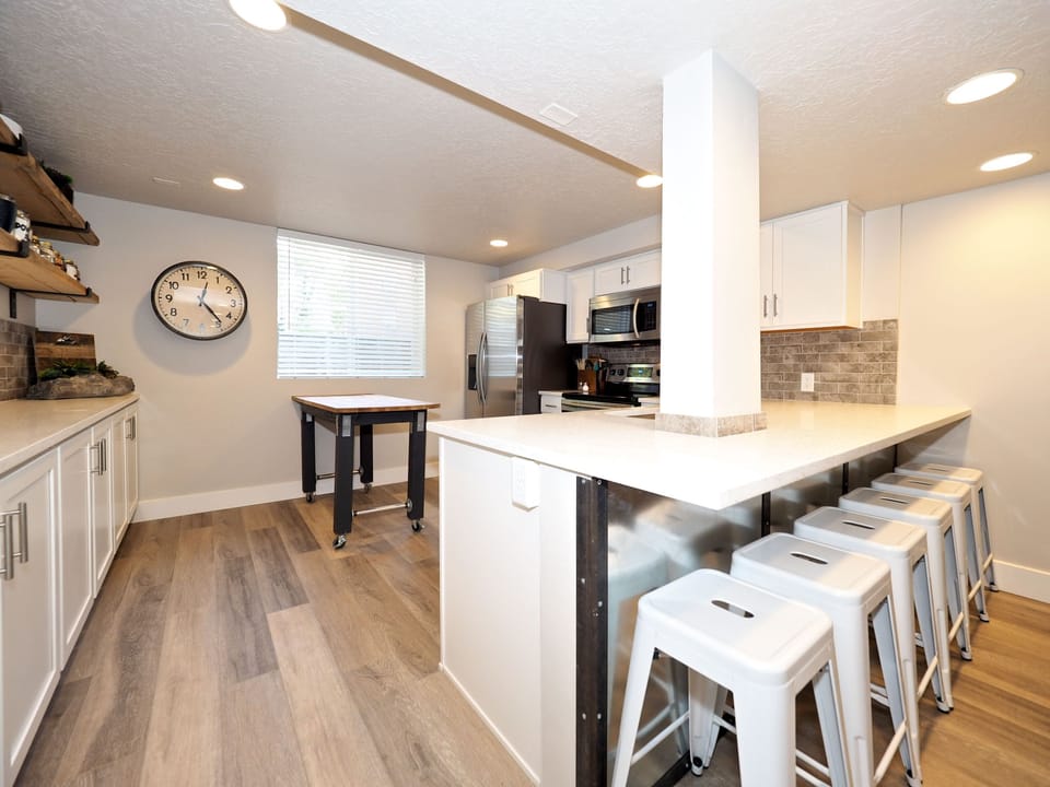 Open concept kitchen with large bar with six stools