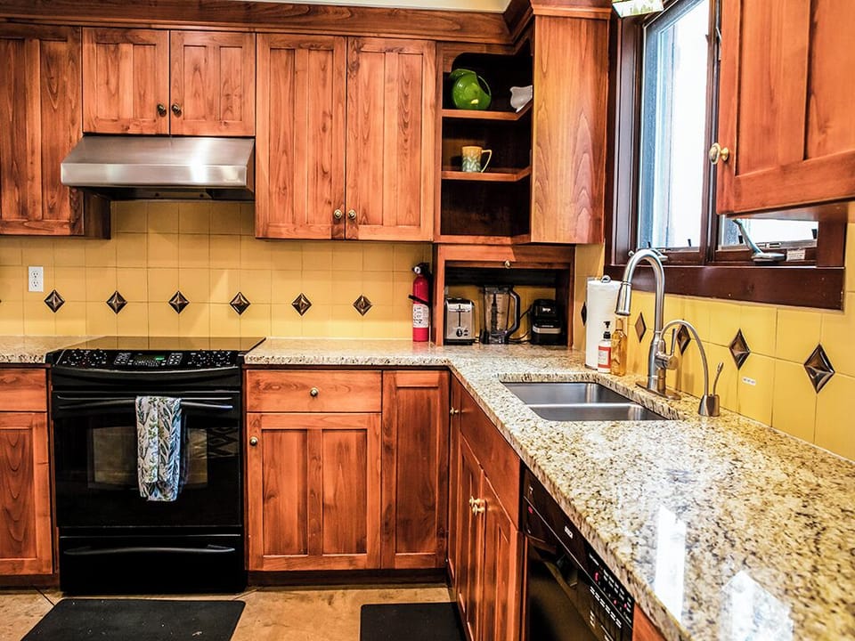 Kitchen Amenities - A photo of the kitchen showing the sink, dishwasher, and oven.