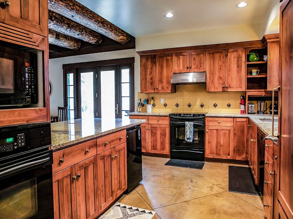 Kitchen from Entryway - A photo of the kitchen from the entryway showing the exterior doors to the grill.