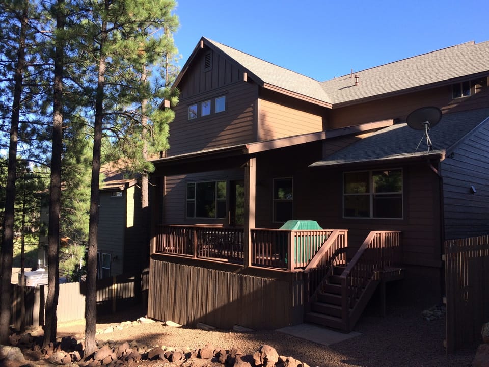 Covered deck with table and BBQ grill.